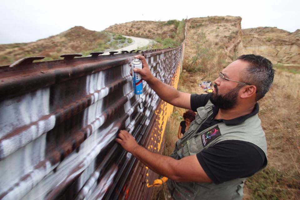 Enrique Chiu painting the Brotherhood Mural